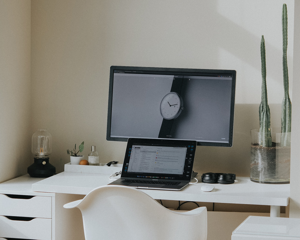 Home office with plants and computer, featuring a DAR Chair.